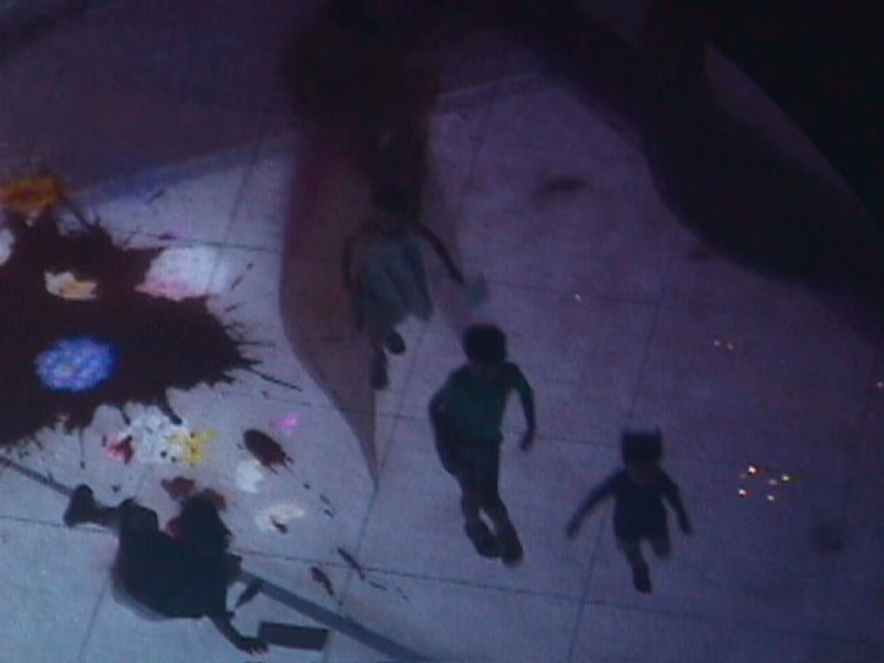 A photo of children playing on a floor with shadows.